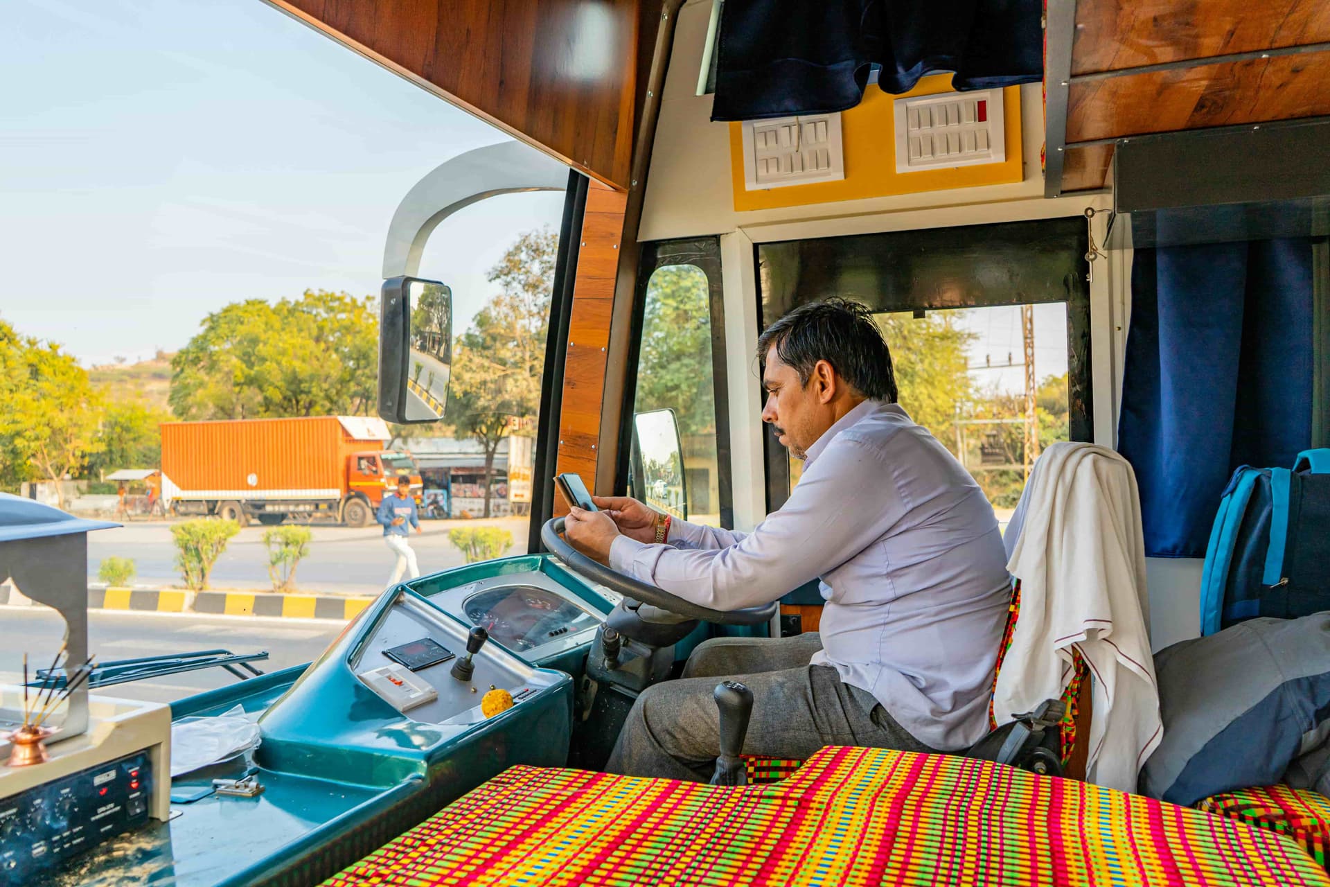 Illustration showing driver looking at a phone with UPI transactions